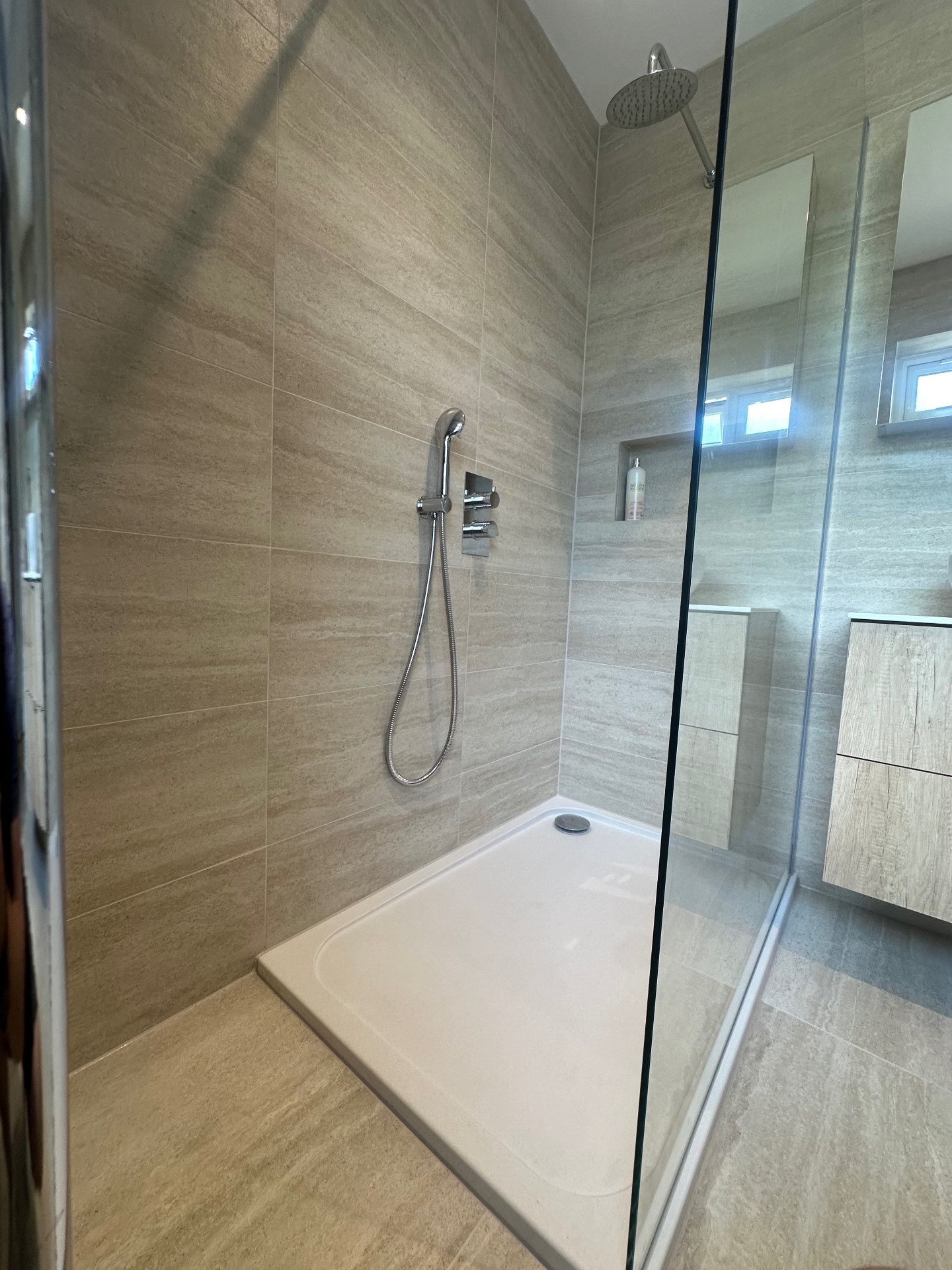 Detail of the walk-in shower with concealed controls and recessed niche