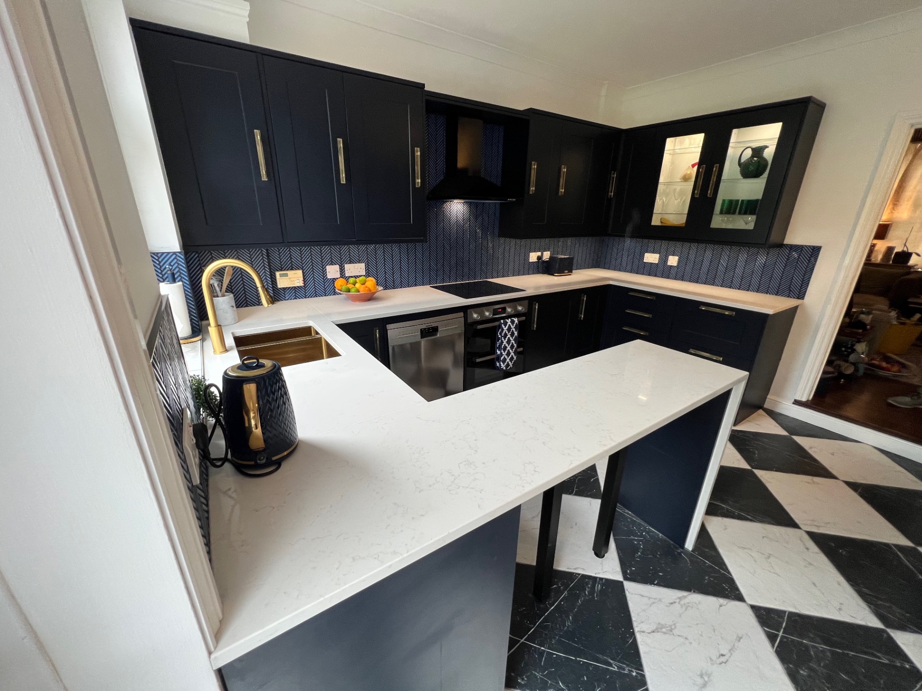 Navy Shaker Kitchen, Earlswood Navy shaker kitchen with quartz worktops, brass tap and black-and-white tiled floor