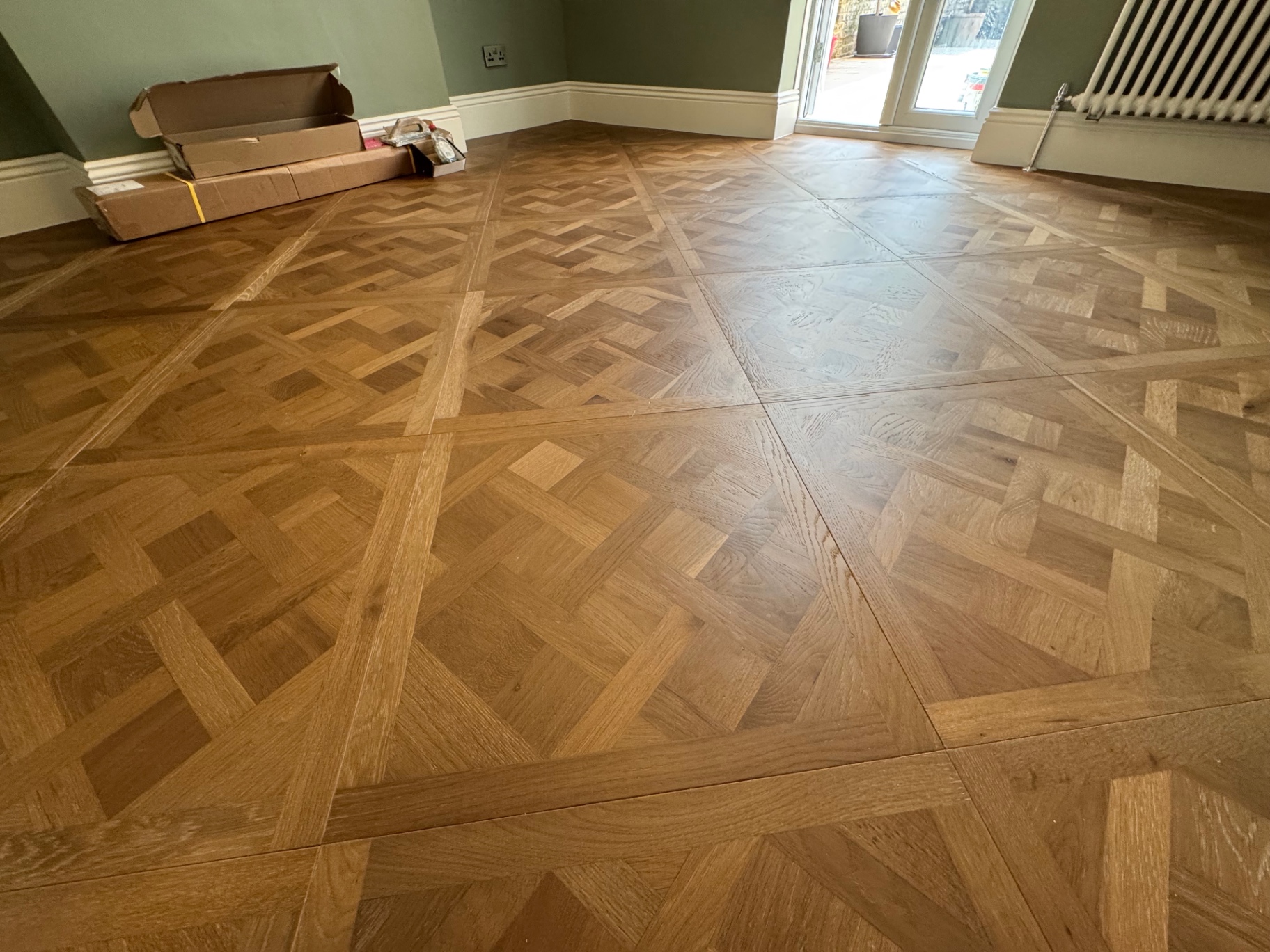 Decorative parquet-style oak flooring laid through the main living space