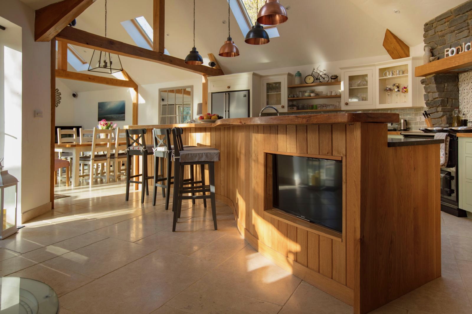 Curved timber island and breakfast bar seating