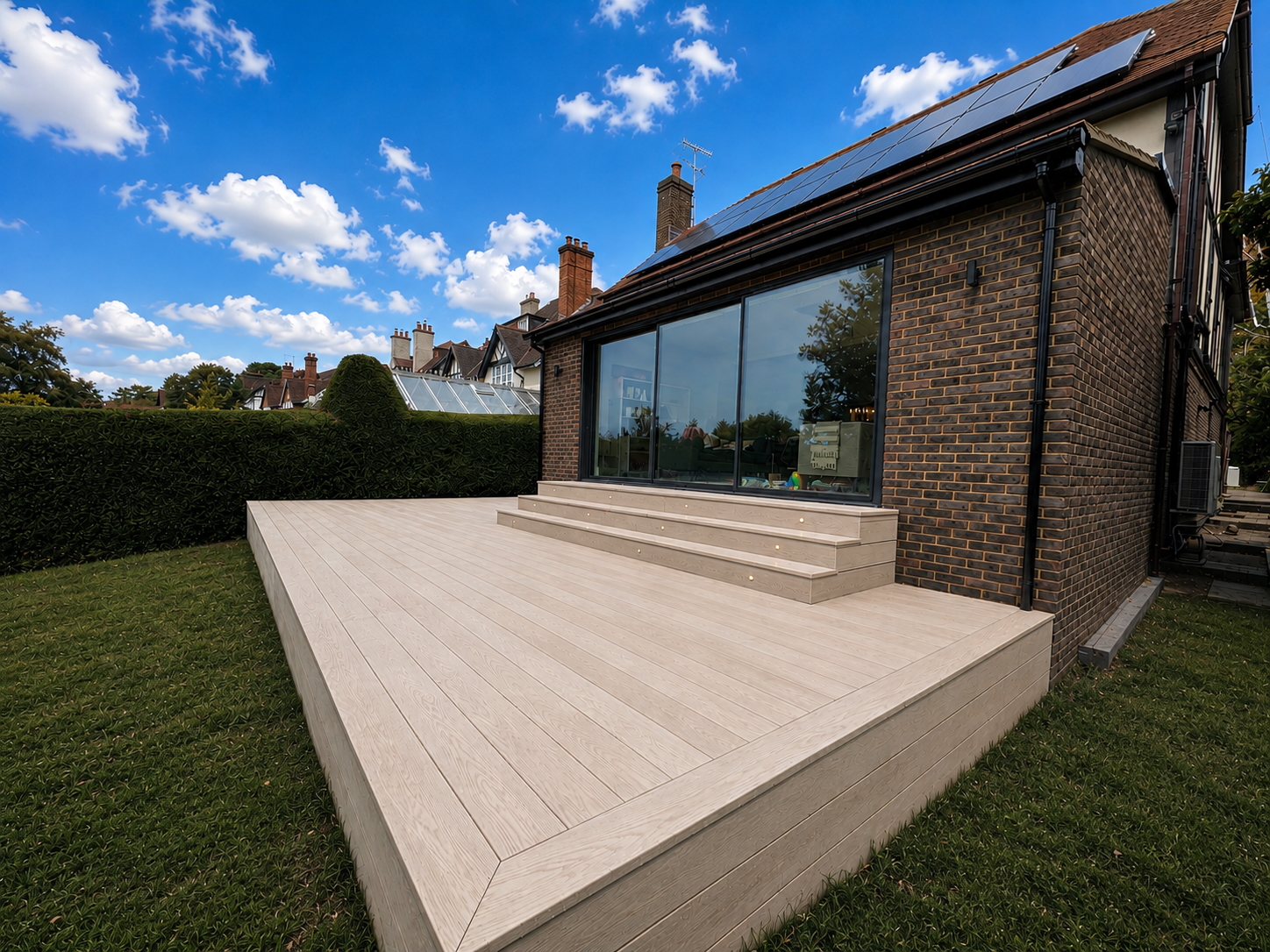 Raised terrace and garden beside the brick rear extension
